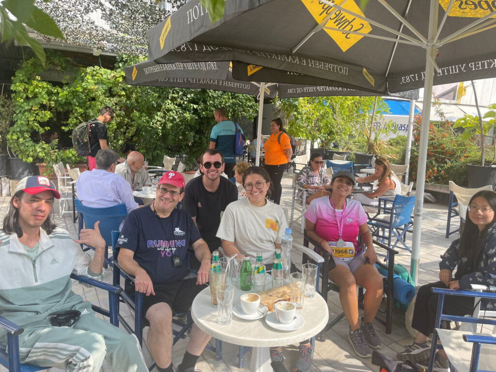 Amateur runners sitting at an outdoor cafe after a race.